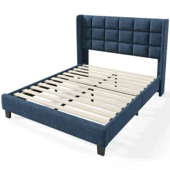 Lit 140x200 cm avec tête de lit tapissée en lin bleu, pieds noirs et sommier à lattes intégré, design élégant><noscript><img width=